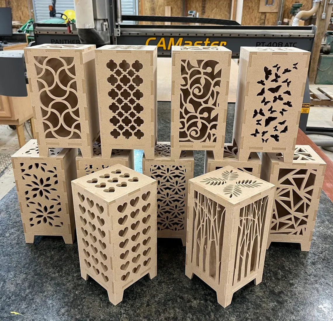 A picture of fiberboard that's been cut with a CNC machine into pretty lanterns.