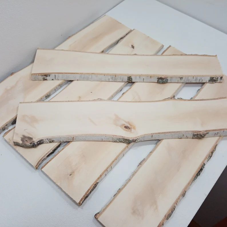 The picture of some raw edge planks of birch wood.