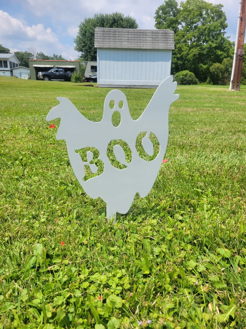 An adorable ghost yard decoration of a ghost with Boo cut outs.