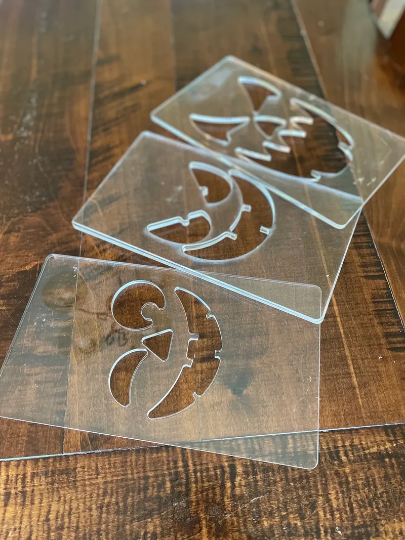 A picture of the acrylic templates you get on a wooden background.