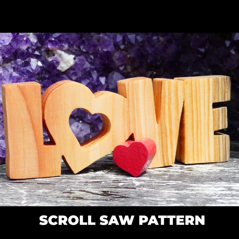 A scroll saw pattern in the shape of LOVE.